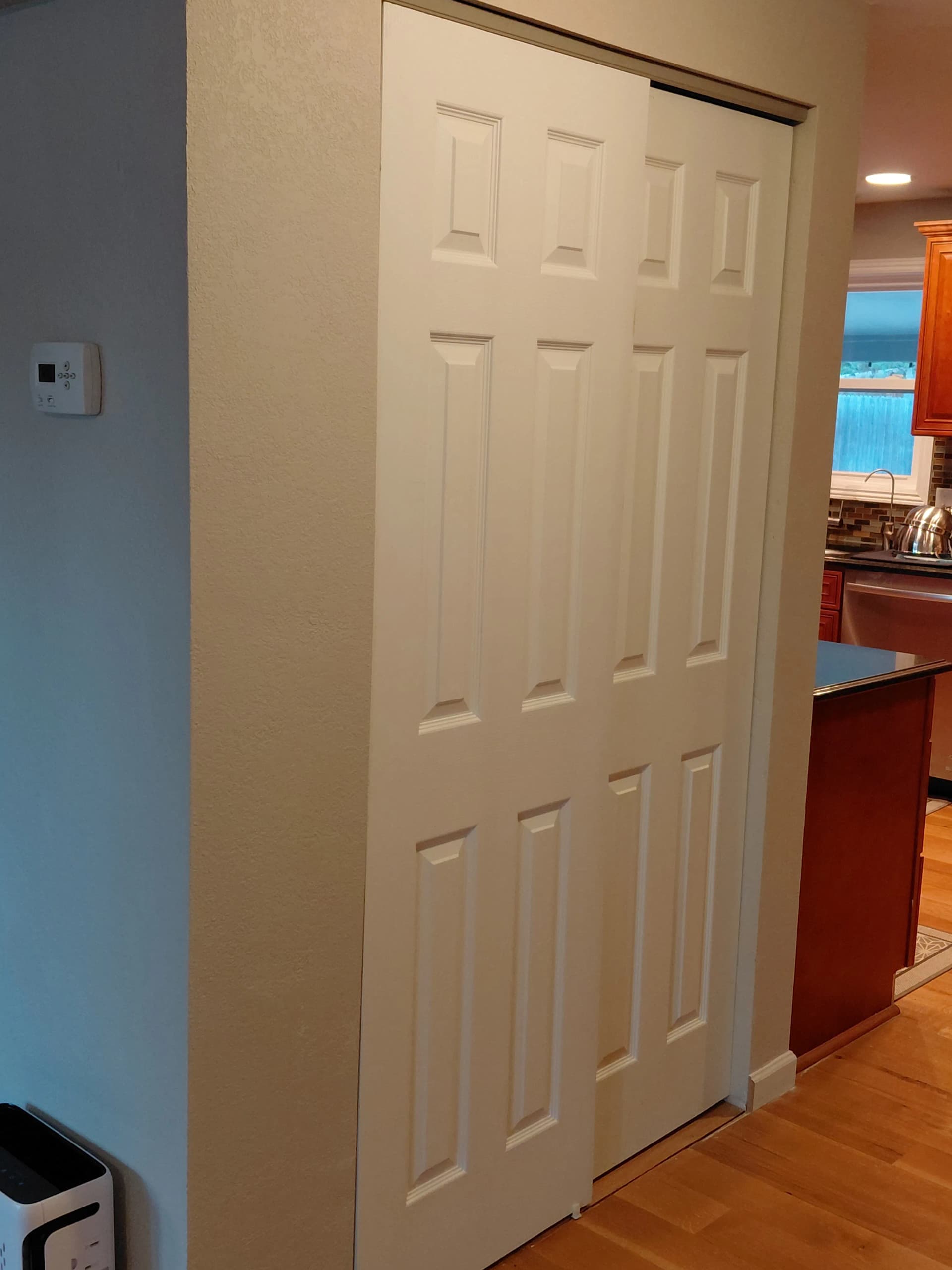 Custom Pantry Cabinets That Hide Behind a Sliding Door image